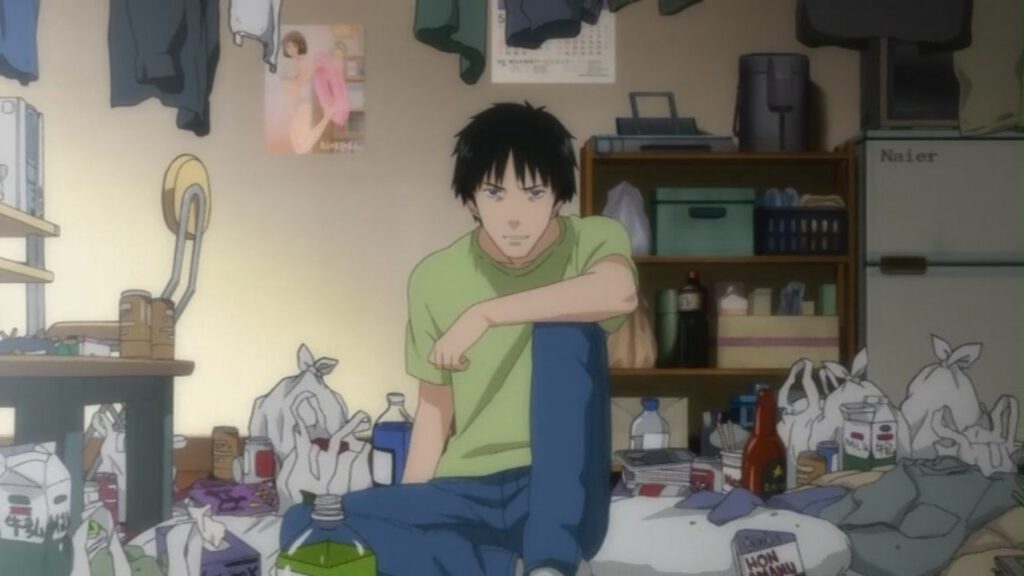 Manga Review - Der Protagonist der Manga Serie Welcome to the N.H.K. Er sitzt in seinem unordentlichem Zimmer und schaut auf den Betrachter.